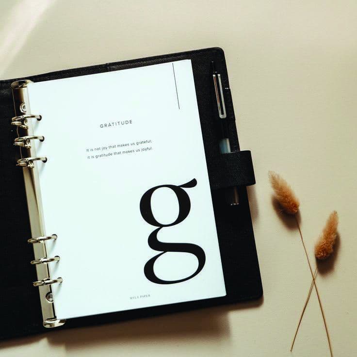 An open Franklin planner with a gratitude page